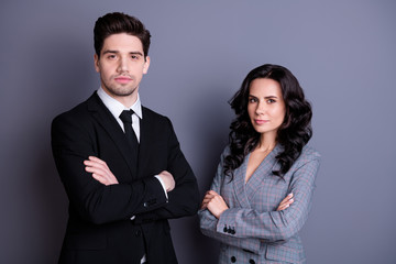 Portrait minded freelancers with wavy curly hairstyle brunet hair crossing hands looking wearing black jacket tux blazer isolated over grey background
