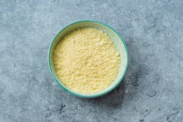 Dry Organic Corn Meal Flour in Ceramic Bowl.