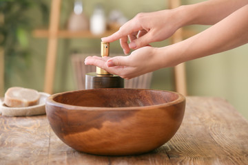 Woman washing hands with soap in bathroom