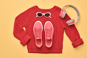 Hipster DJ trendy colorful autumn Outfit. Fall fashion minimal Flat lay. Red jumper, Stylish sneakers, headphones.Creative Woman Clothes Accessories layout, fall Girl fashionable autumnal orange color