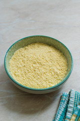 Dry Organic Corn Meal Flour in Ceramic Bowl.