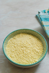 Dry Organic Corn Meal Flour in Ceramic Bowl.