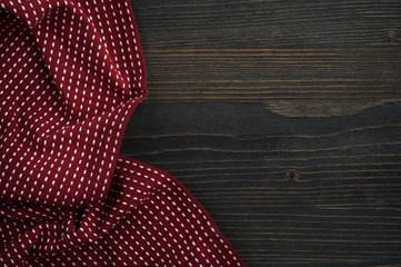 Dark wooden background with red napkin