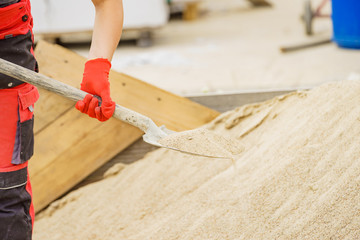 Woman using shovel on constriction site