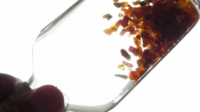 pieces of amber in water falling to the bottom slow motion