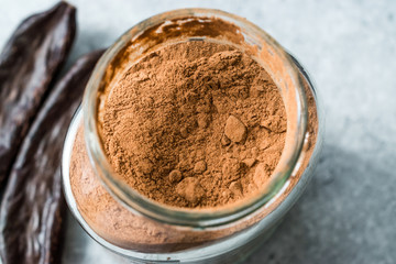 Carob Powder and Pods Ready to Use in Jar.