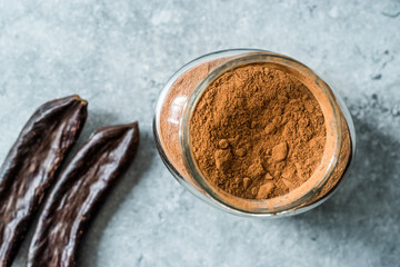 Carob Powder and Pods Ready to Use in Jar.
