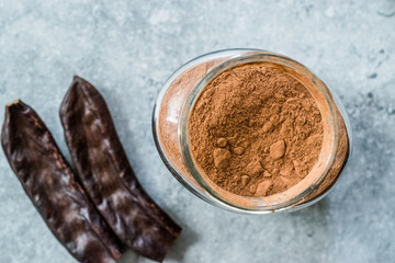 Carob Powder and Pods Ready to Use in Jar.