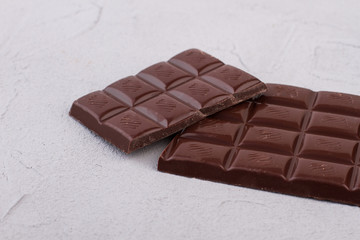 Chocolate bars on light background. Two milk chocolate bars. Sweets for gourmet.