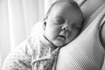 Mother with her sleeping little baby, closeup