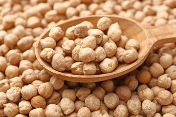 Spoon on many raw chickpea, closeup