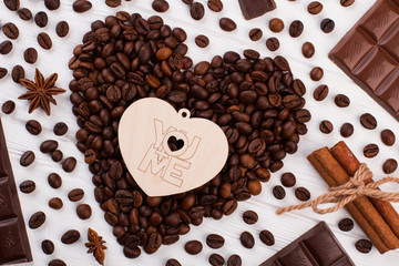 Heart from coffee beans on wooden background. Romantic design for Valentines Day.