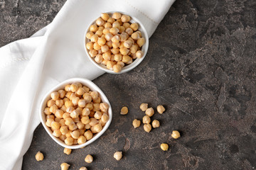 Bowls with raw chickpea on table