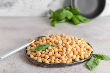 Plate with raw chickpea on table