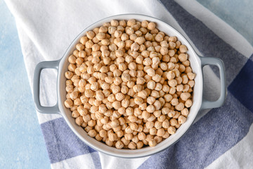 Pot with raw chickpea on table