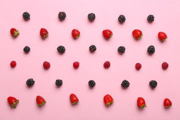 Many sweet ripe berries on color background
