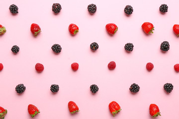 Many sweet ripe berries on color background