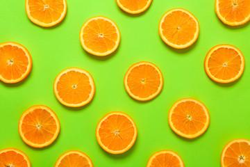 Many orange slices on color background