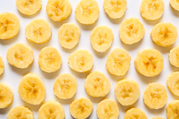 Many banana slices on white background