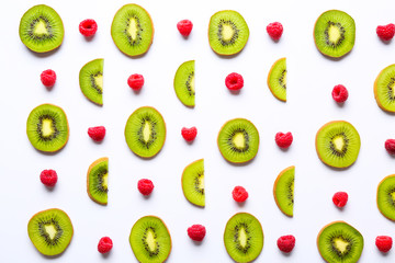 Many sweet ripe kiwi and raspberry on white background