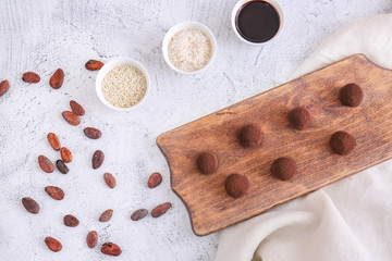 Board with tasty sweet truffles on light background