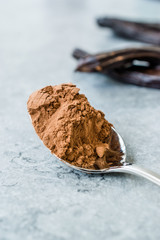 Carob Powder and Pods Ready to Use in Spoon