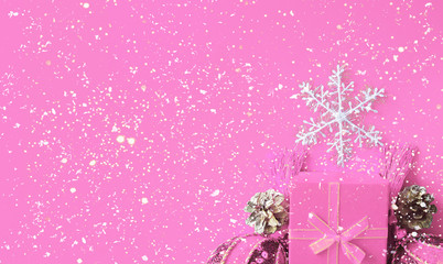 Decorative white snowflake, pink present box, golden cones and shiny derative balls