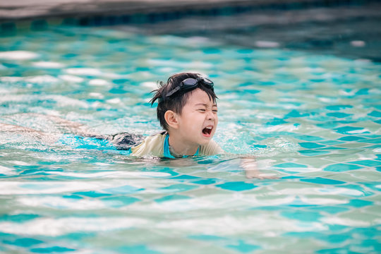 The boy is crying in swimming pool