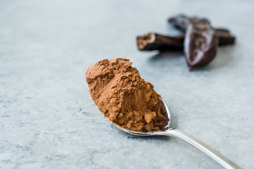 Carob Powder and Pods Ready to Use in Spoon