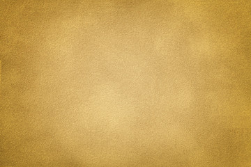 Golden matt suede fabric closeup. Velvet texture.