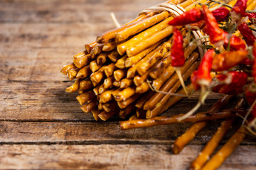 Pile of Salty bread sticks on a wooden table