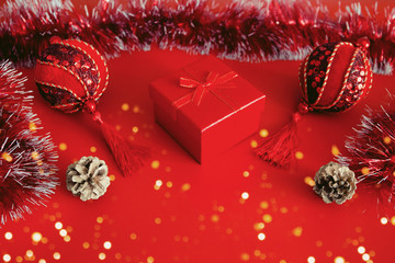 Red present box, golden cones and shiny derative balls
