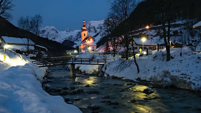 Night to day winter timelapse of famous Parish church St. Sebastian, in Ramsau, Berchtesgaden, Bavarian Alps Germany.
