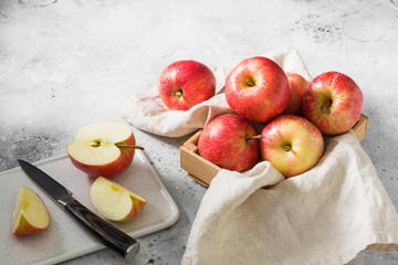 Apples in a basket on a gray background. Autumn harvest