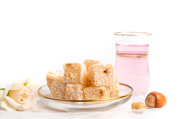 Turkish delight dessert with hazelnuts and rose tea