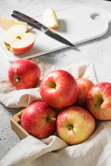 Naklejka na ściany i meble Apples in a basket on a gray background. Autumn harvest
