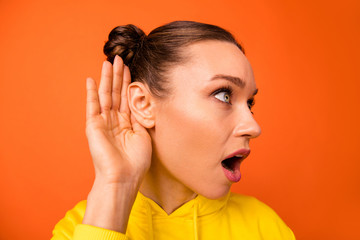 Profile side photo of astonished youth put hands near ears opening mouth isolated over orange background