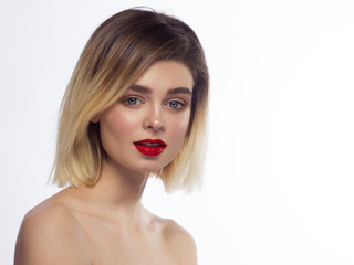 Close-up of the beauty of the female face with a classic evening make-up. Smooth black shadow on the eyelids, long eyelashes and red lips. Beauty and cosmetology. Clean face skin