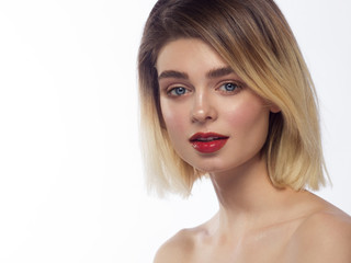 Close-up of the beauty of the female face with a classic evening make-up. Smooth black shadow on the eyelids, long eyelashes and red lips. Beauty and cosmetology. Clean face skin