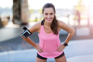 Female runner smiling during urban workout 