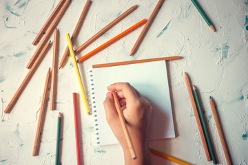 Color pencils on a white background. School desk