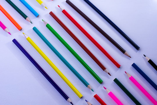 Pattern of wooden color pencils on a white background. Minimal beauty concept. Copy space concept back to school, learning process, study at school, drawing