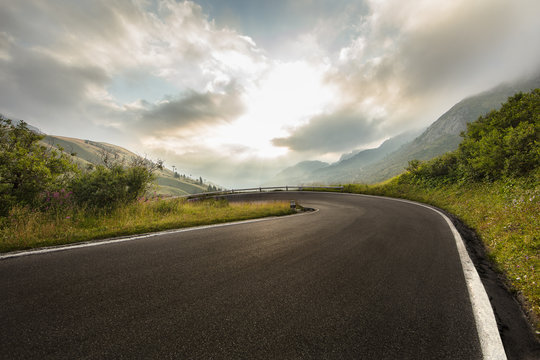 Asphalt road in Dolomites in a summer day, Italy.