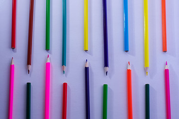 Pattern of wooden color pencils on a white background. Minimal beauty concept. Copy space concept back to school, learning process, study at school, drawing