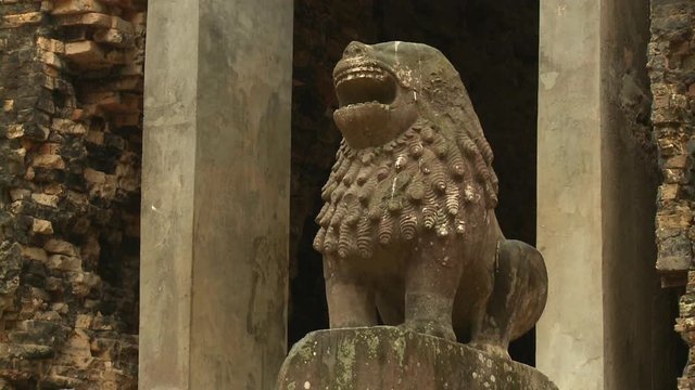 A daylight closeup shot of one of the carved stone lions at the entryway passage of the Khmer ruins of Sambor Prei Kuk located in the north of the city of Kampong Thom of Cambodia. .