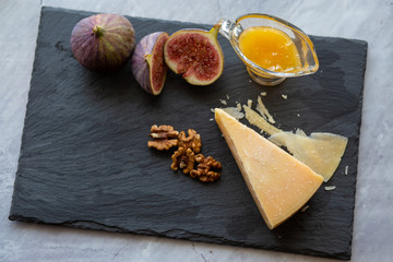 Ripe hard cheese with honey and figs.Ripe Cheddar with Red Wine