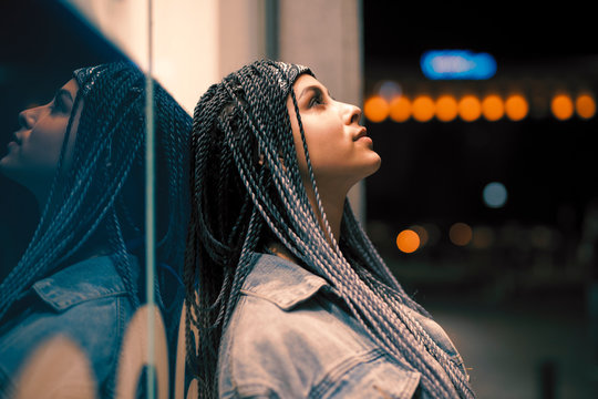 Portrait Of Young Unusual Woman Leaning On Building In The Night City