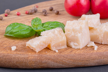 Pieces of Rigiano parmesan, cherry tomato and basil leaf