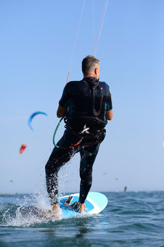 Kite surfer having fun on a beautiful sunny and windy day. Extreme sports and fun. Kitesurfing lessons. Sea and sun. Extreme watersports.