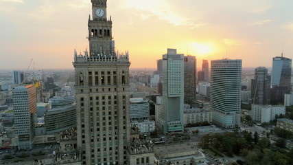 Aerial Panoramic View of Warsaw City Centre at Sunset, Poland, Europe. Urban Skyline with Skyscrappers, Car Roads and Main Landmark - Palace of Culture and Science.